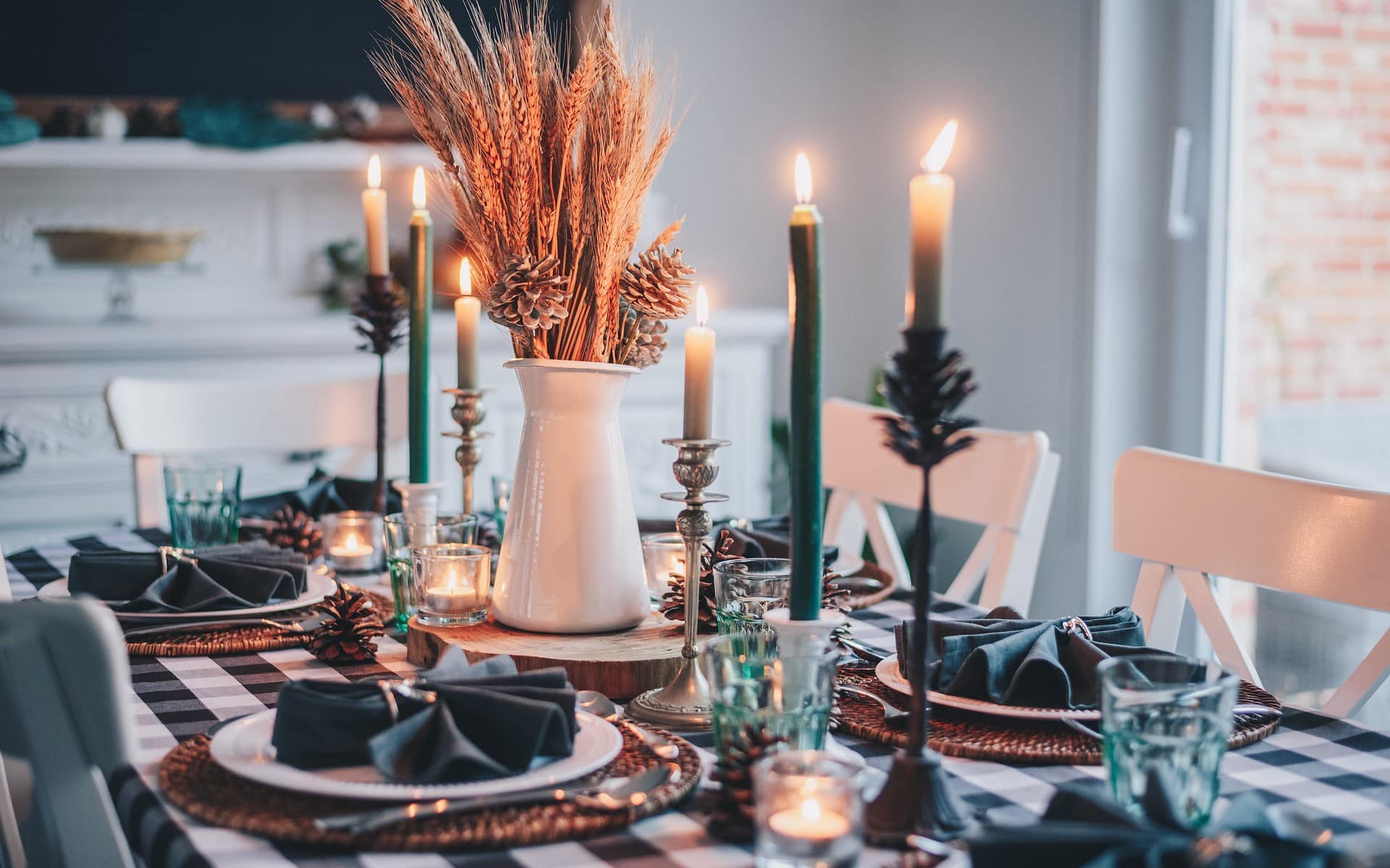 a dinner table set with holiday decor for fall
