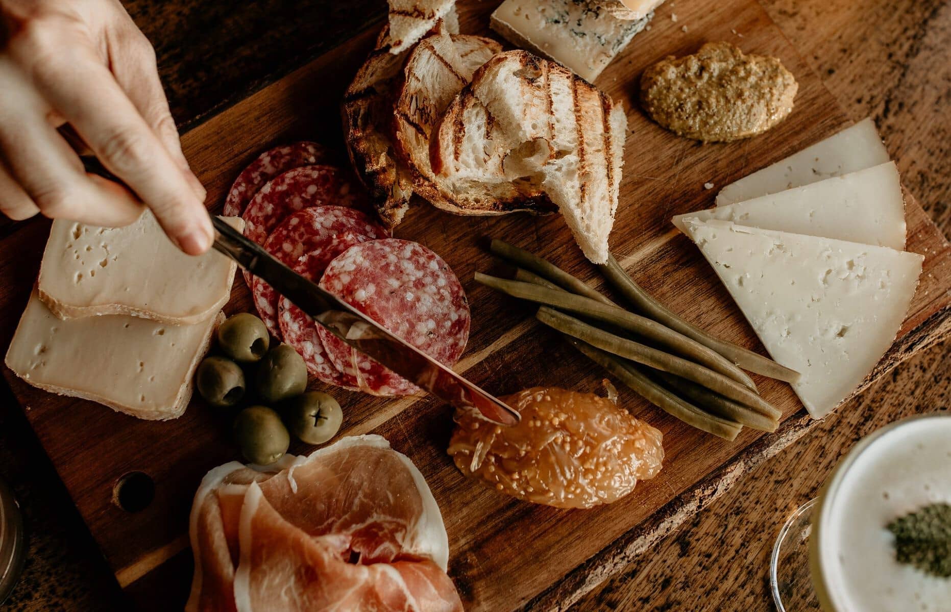 charcuterie board with salami, prosciutto, cheese and pita bread
